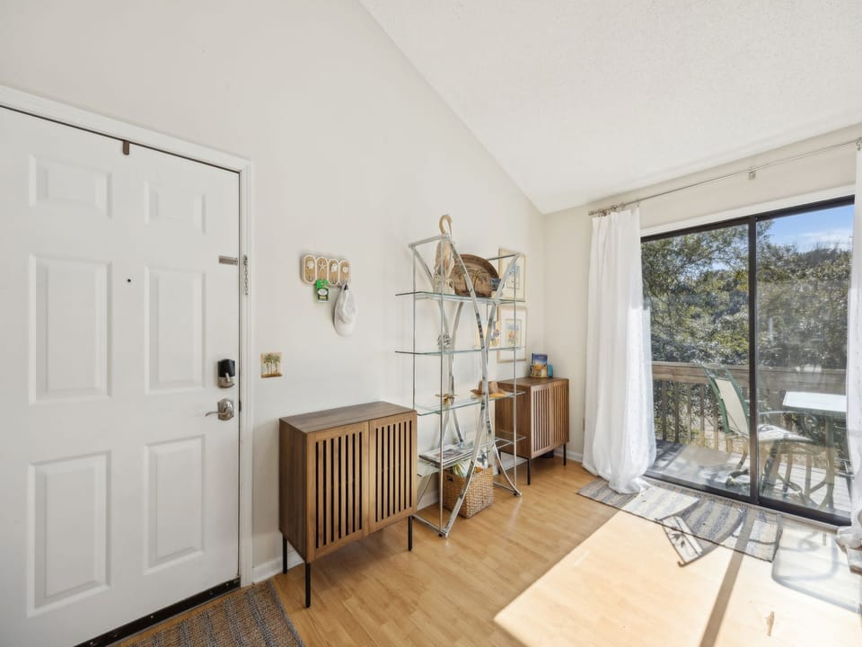 Relax in your bright living space with natural light streaming through sliding doors to your private balcony overlooking peaceful trees.