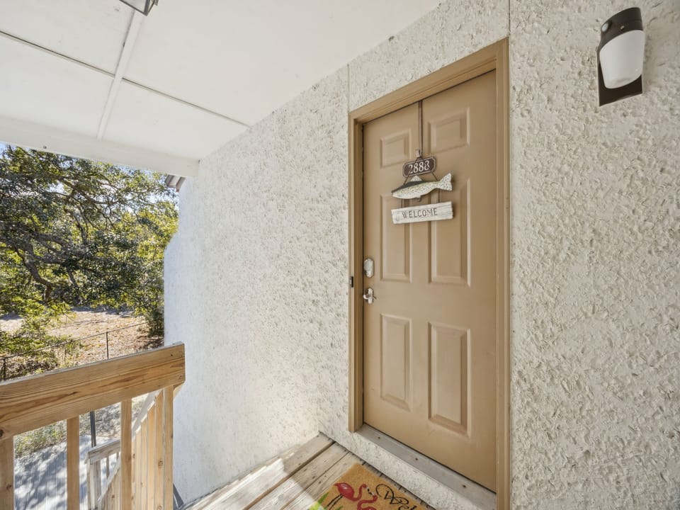 Your private entrance welcomes you with a charming covered entryway and peaceful natural views.