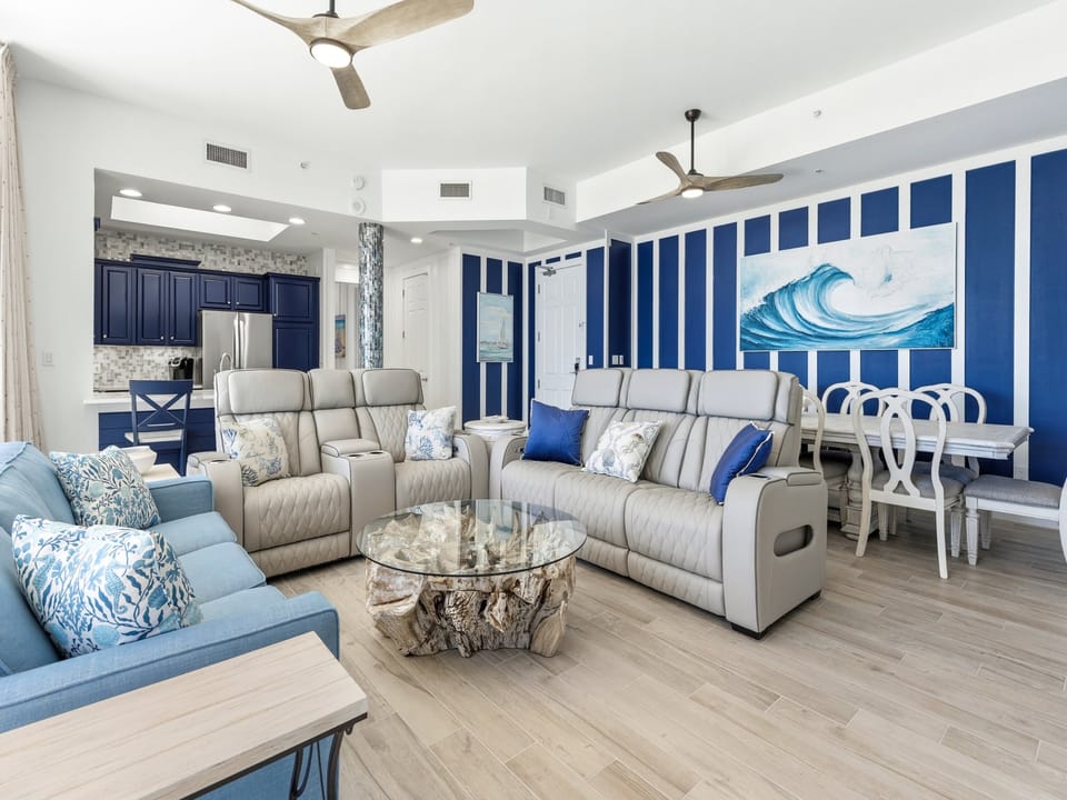 Unwind in this stunning coastal living space where ocean-inspired blues meet modern comfort, perfect for your beach getaway relaxation.