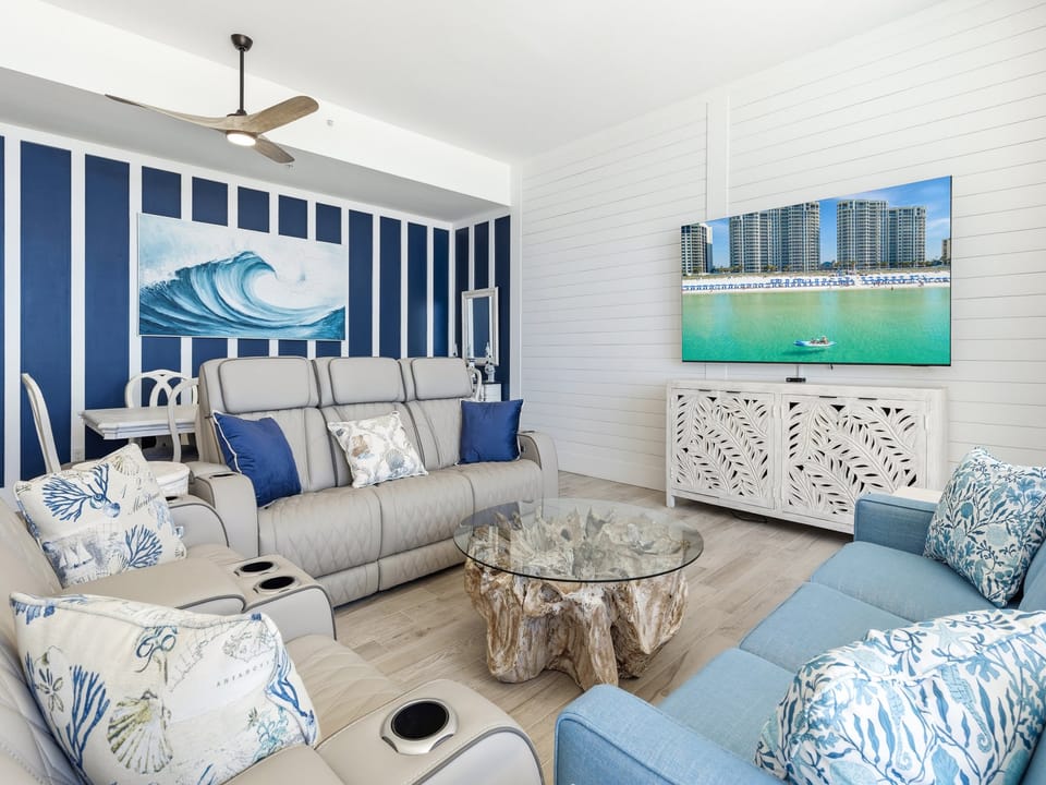 Relax in your coastal-themed living room with ocean wave art and comfortable seating for movie nights.