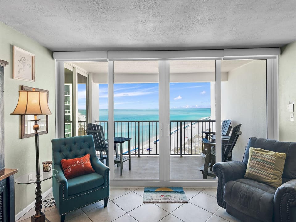 Step into your oceanfront living room where turquoise waters fill every window and your private balcony awaits with stunning sea views.