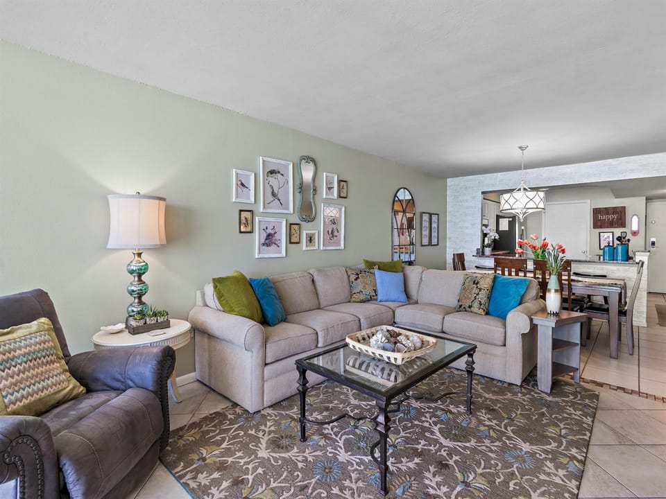 Settle into your spacious living area with plush sectional seating, colorful accent pillows, and thoughtful touches that make you feel right at home.