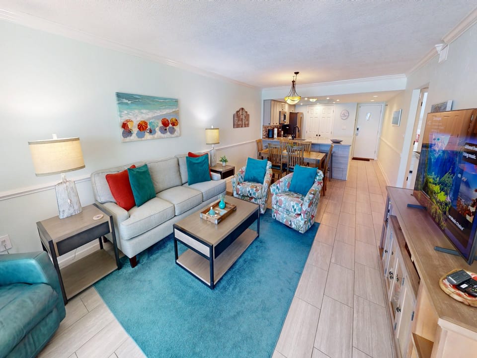 Your bright, coastal-themed living space features a comfortable sectional sofa and vibrant turquoise accents that perfectly complement the ocean artwork above.