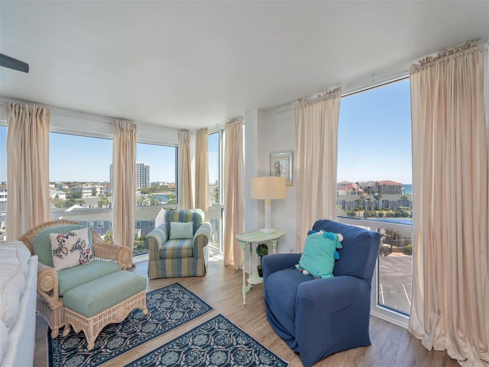 Sink into coastal comfort in your light-filled living room with panoramic city views stretching to the horizon through floor-to-ceiling windows.