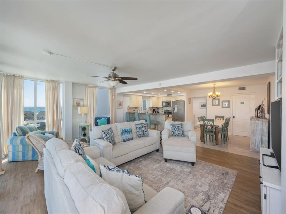 Relax in this bright, coastal-inspired living space where soft blues meet comfortable seating and stunning views.