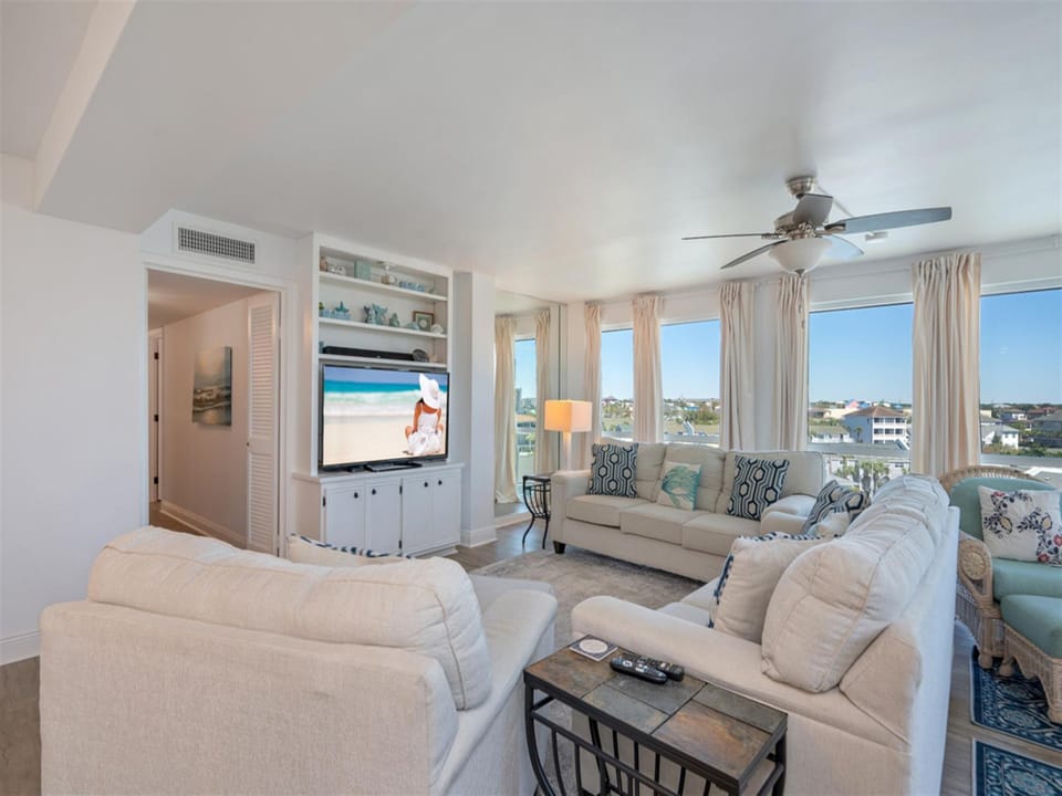 Relax in your bright living room with coastal views, plush seating, and entertainment center for perfect vacation evenings.