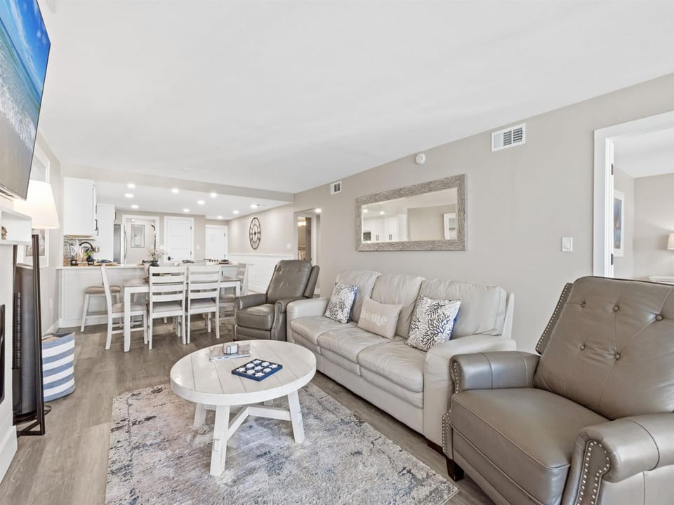Relax in your stylish open-plan living space with plush leather seating and modern coastal touches throughout.