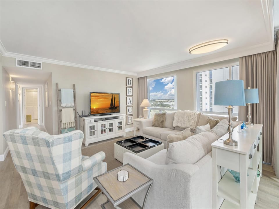 Sink into plush sectional seating while enjoying ocean views through floor-to-ceiling windows in your stylish coastal retreat.