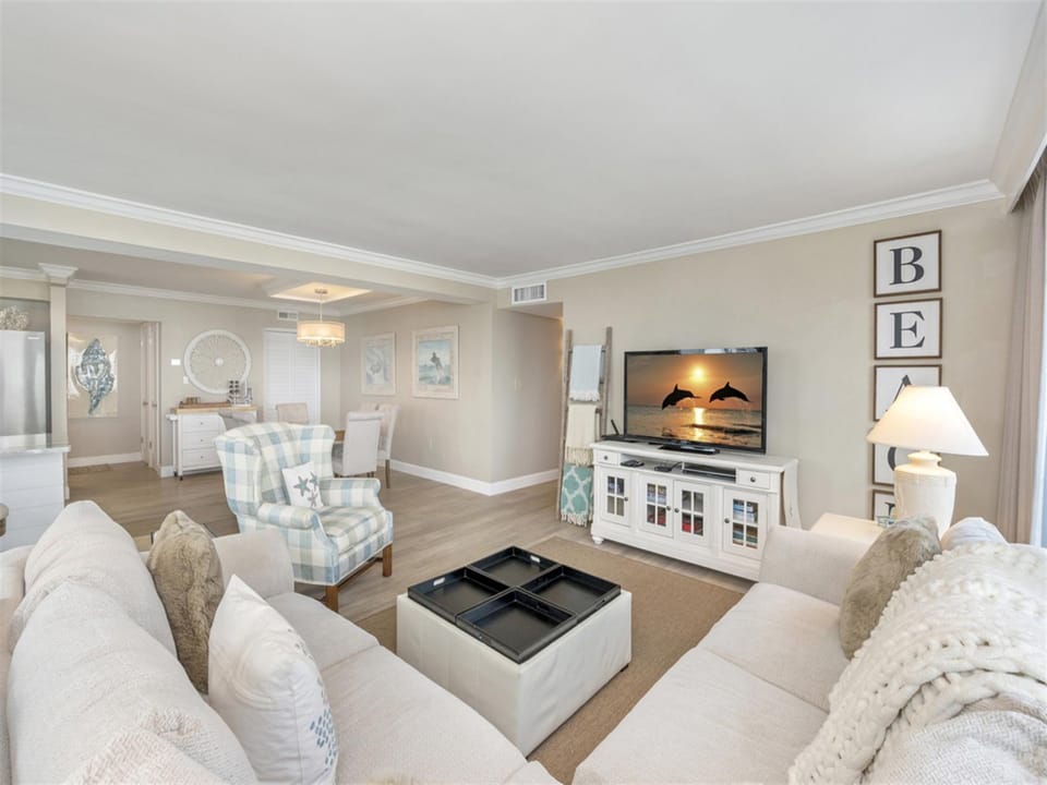 Sink into plush sofas and unwind in your elegantly appointed living space, where coastal charm meets modern comfort for perfect relaxation.
