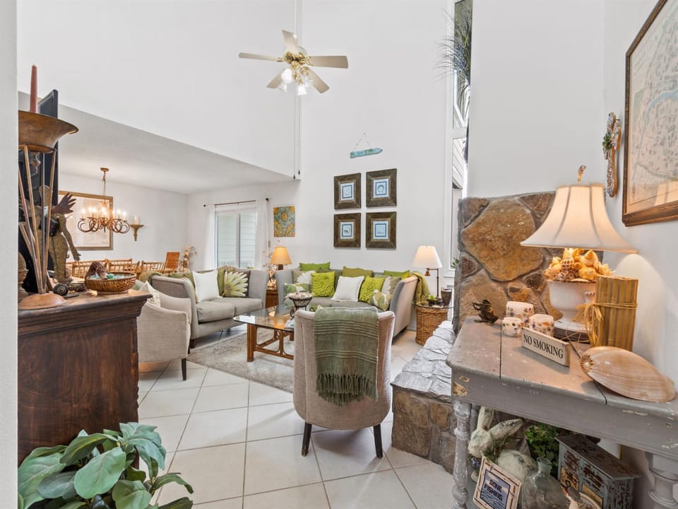 Sink into plush seating surrounded by warm coastal decor and thoughtful touches that make this inviting living space feel like home.
