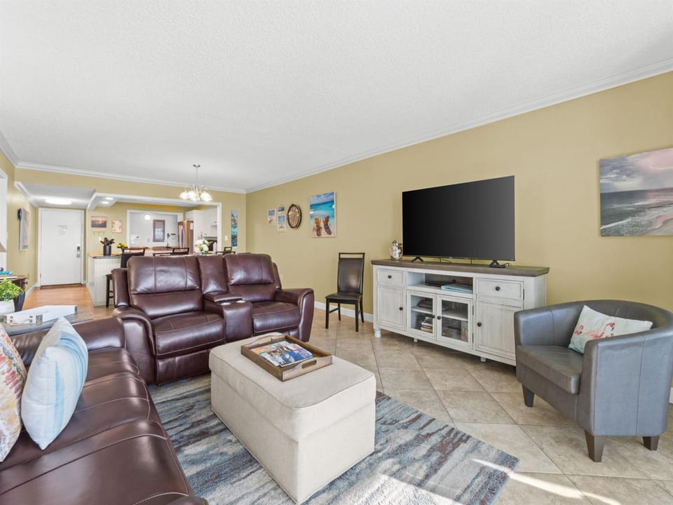 Sink into rich leather seating while you watch your favorite shows on the large flat-screen TV in this spacious, sunlit living area.