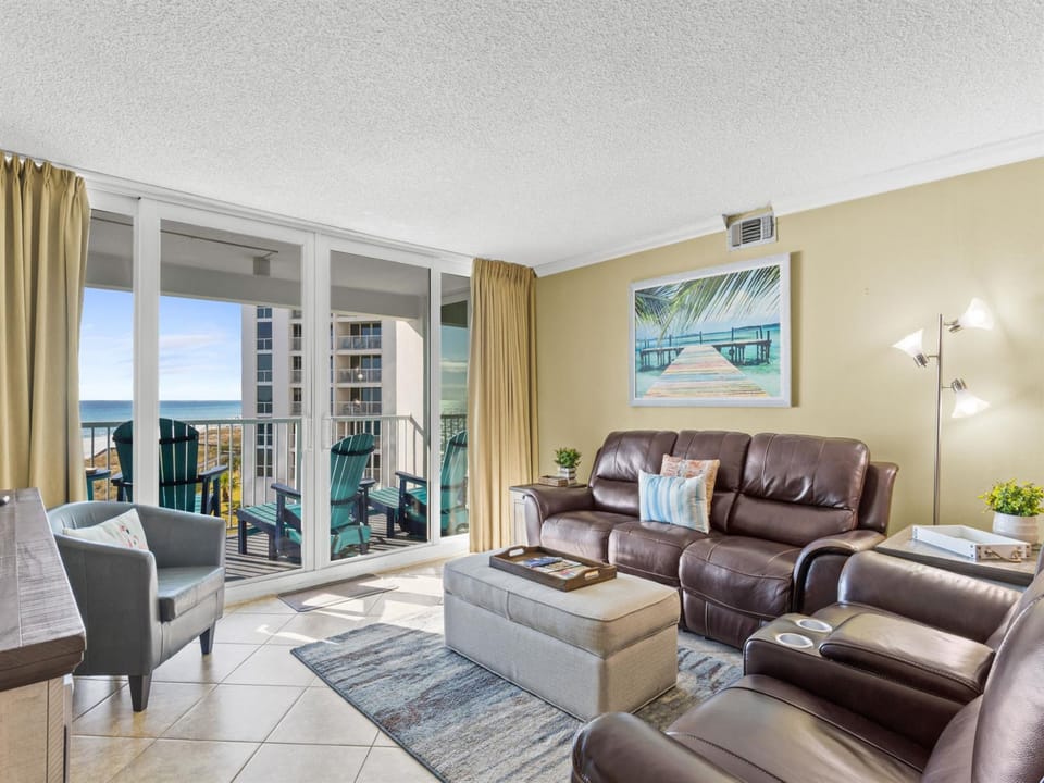 Sink into plush leather seating while enjoying your private balcony with stunning ocean views through floor-to-ceiling windows.