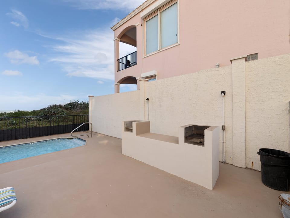Community grilling area, perfect for casual outdoor meals after a day at the beach.