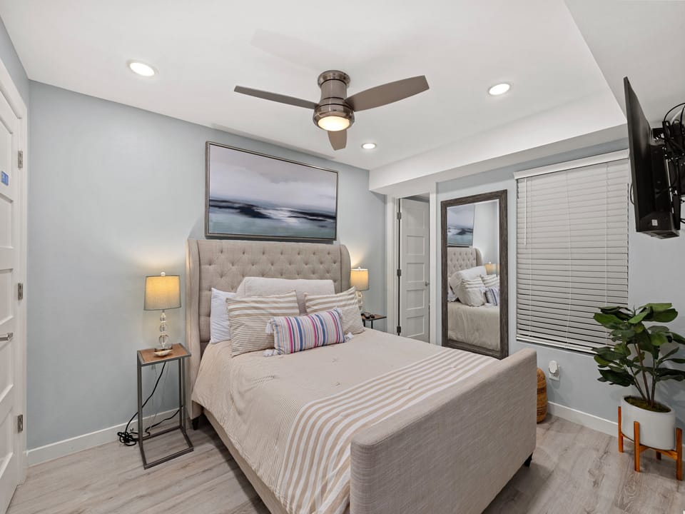 Unwind in the comfortable primary bedroom, designed for restful nights after a day at the beach.