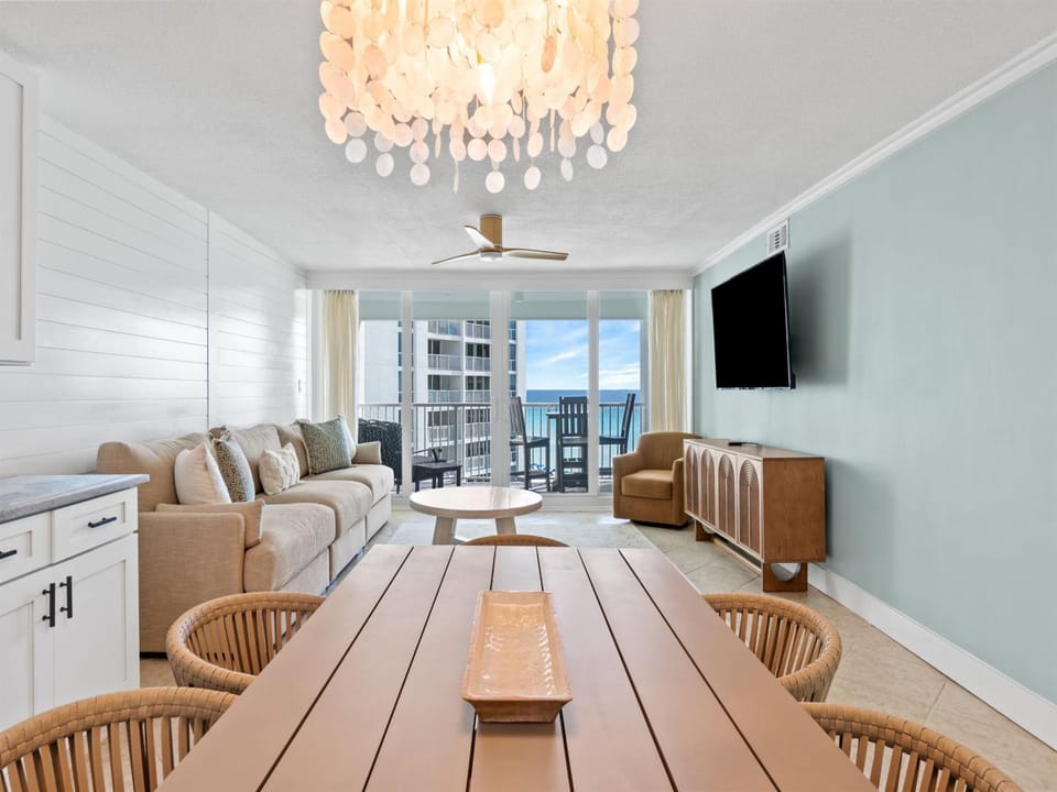 Relax in your stylish living space featuring coastal-inspired decor, comfortable seating, and a spectacular balcony view.