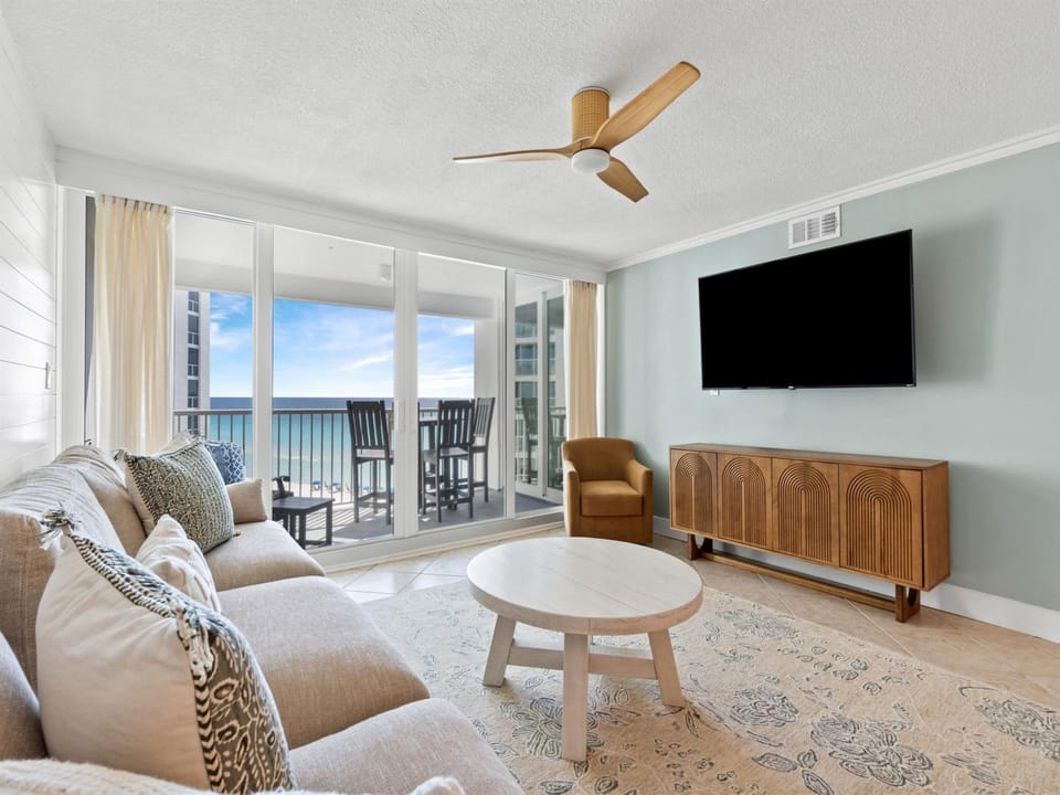 Unwind in your stylish living room where ocean views frame your relaxation time through floor-to-ceiling windows.