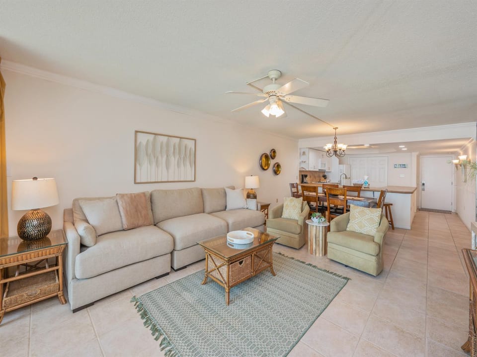 Unwind in this spacious, light-filled living room with plush sectional seating and open-concept design flowing seamlessly to your fully equipped kitchen.
