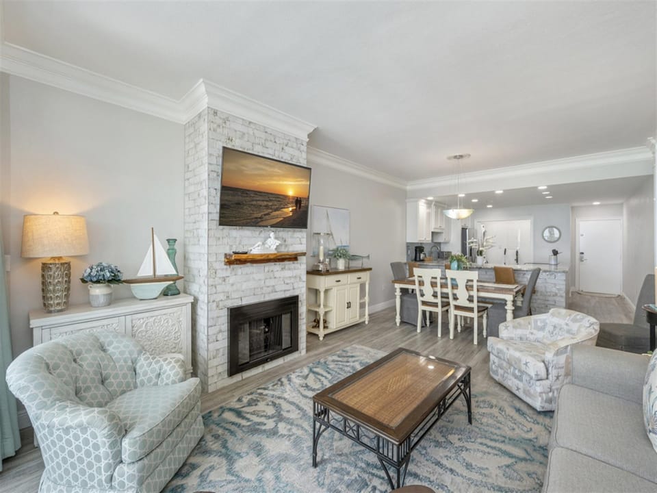 Unwind in your elegant coastal retreat, where a cozy fireplace and open living flow perfectly into your fully equipped kitchen—ideal for memorable evenings together.
