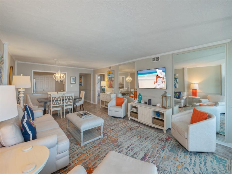 Relax in your elegantly appointed living space featuring plush seating, coastal decor, and modern entertainment.