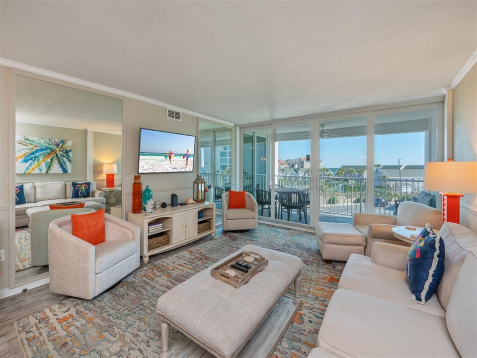 Relax in your bright living room with panoramic views, comfortable seating, and vibrant coastal touches that make you feel right at home.