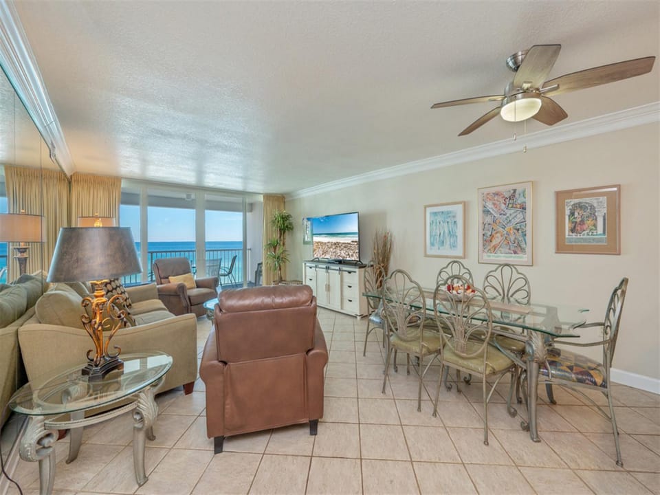 Unwind in your elegant oceanfront living space where coastal artwork and comfortable seating create the perfect retreat for relaxing.