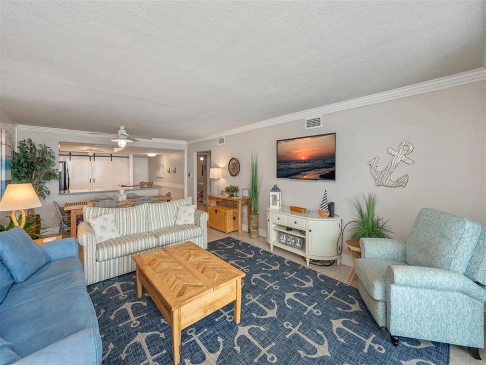 Relax in your coastal-themed living space with comfortable seating, ocean artwork, and nautical touches that make you feel right at home.