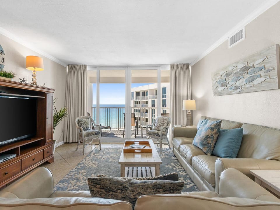 Sink into plush leather seating while ocean waves sparkle beyond your floor-to-ceiling windows, creating the perfect coastal retreat.