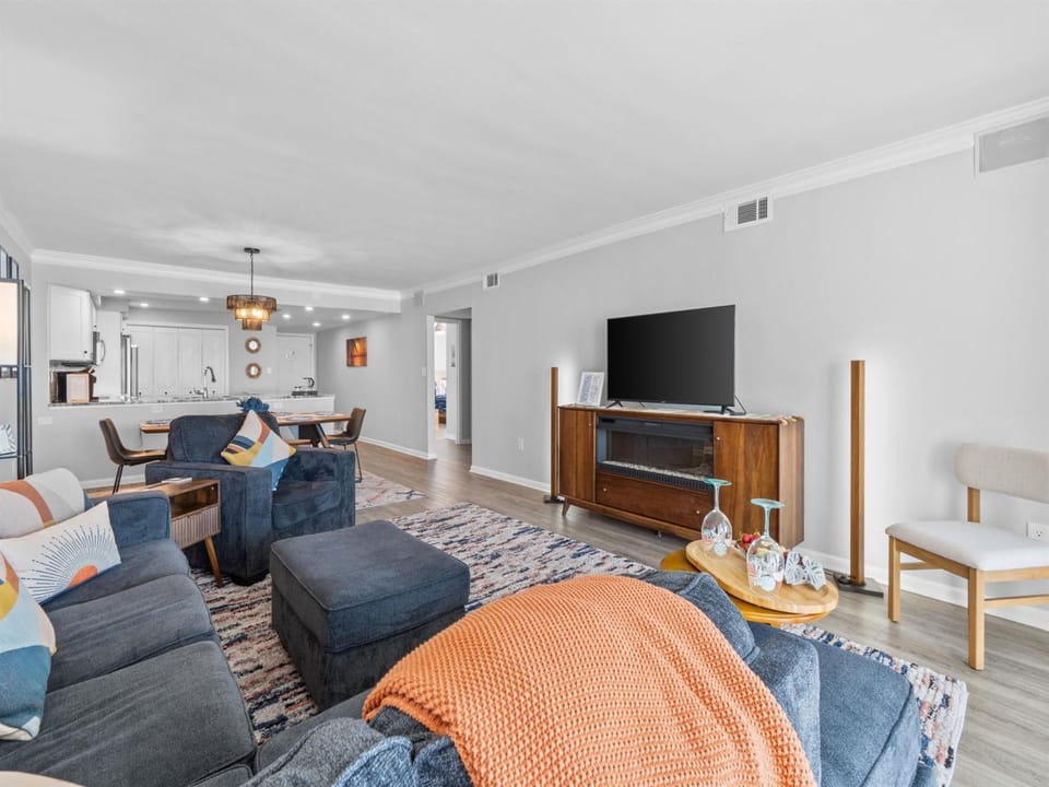 Sink into plush navy sofas and unwind in your spacious living area, complete with modern entertainment and an open kitchen for effortless gatherings.