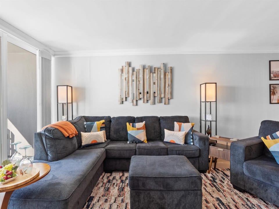 Sink into plush sectional seating with vibrant pillows, perfect for movie nights or morning coffee in your stylish retreat.
