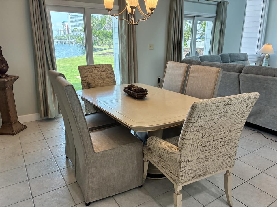Gather around this elegant dining table where waterfront views create the perfect backdrop for your memorable meals together.