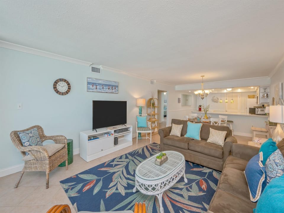 Relax in your bright, coastal-inspired living space with comfortable seating, modern amenities, and an open kitchen perfect for vacation memories.