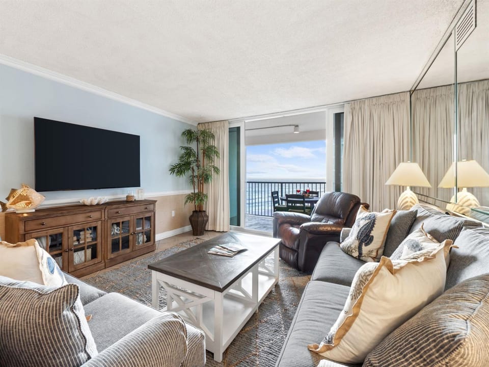 Sink into plush seating while watching your favorite shows on the large TV, with stunning ocean views just steps away on your private balcony.
