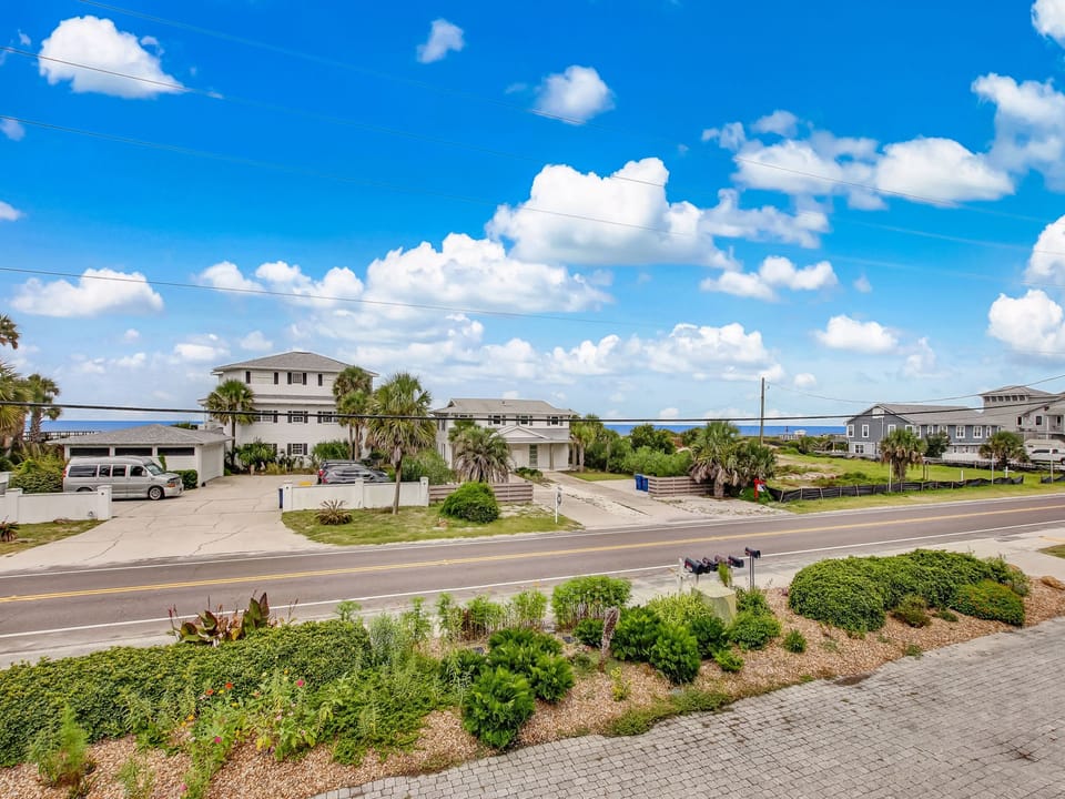 Coastal neighborhood setting with easy access to local attractions and beautiful blue skies overhead.