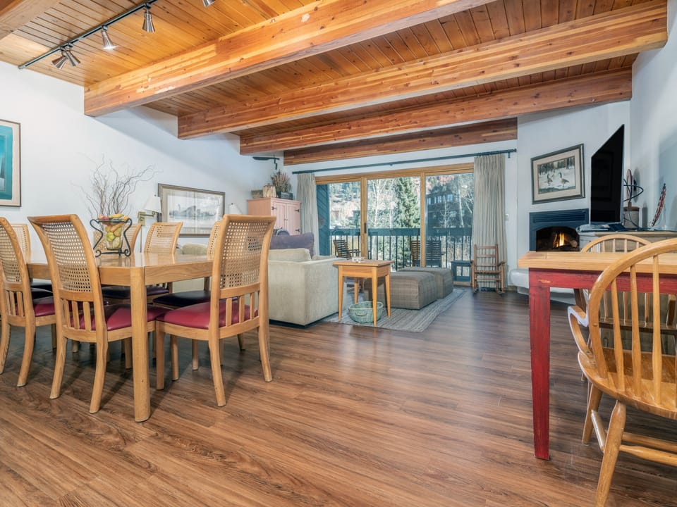 Gather around your spacious dining table beneath stunning wood beam ceilings, then unwind by the fireplace while enjoying mountain views through your private balcony.