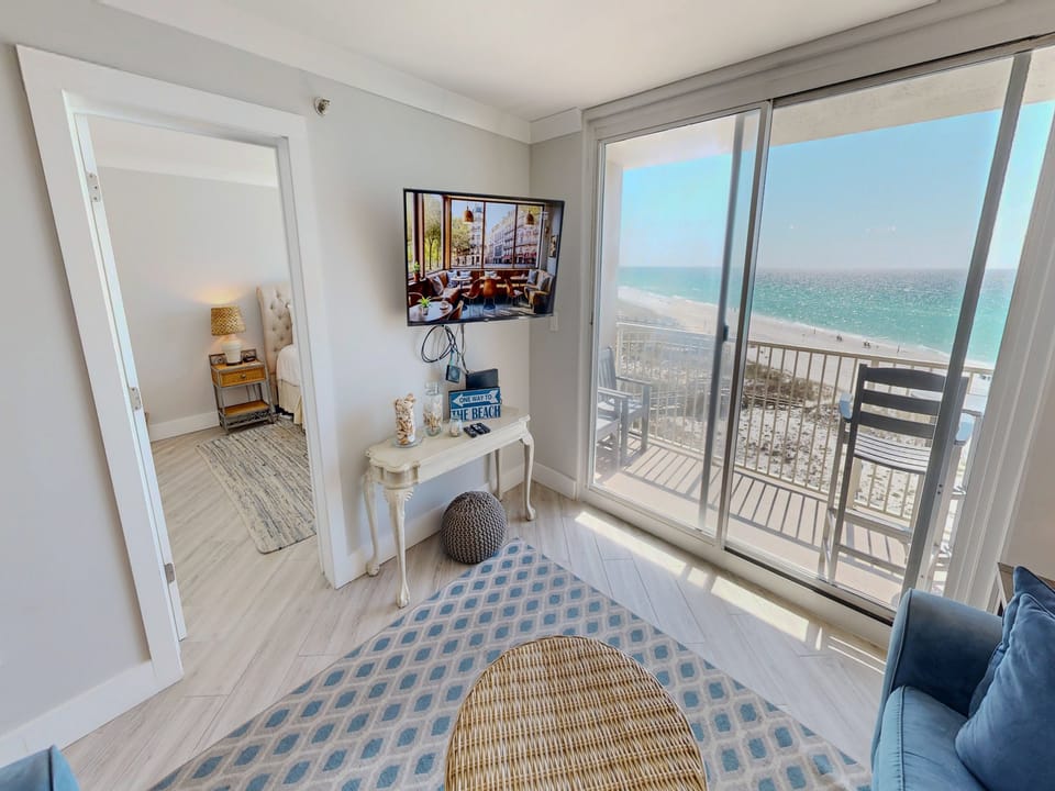 Unwind in your bright oceanfront living room with stunning sea views and direct balcony access to watch waves roll in.