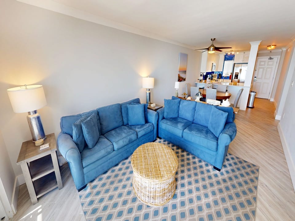 Sink into plush blue sectional seating where ocean-inspired comfort meets coastal style, perfect for gathering with loved ones.
