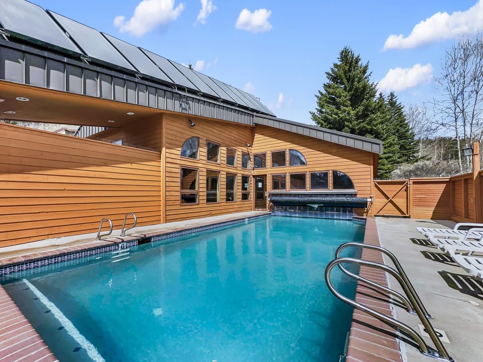Dive into your own private heated pool surrounded by stunning wood architecture and mountain views.