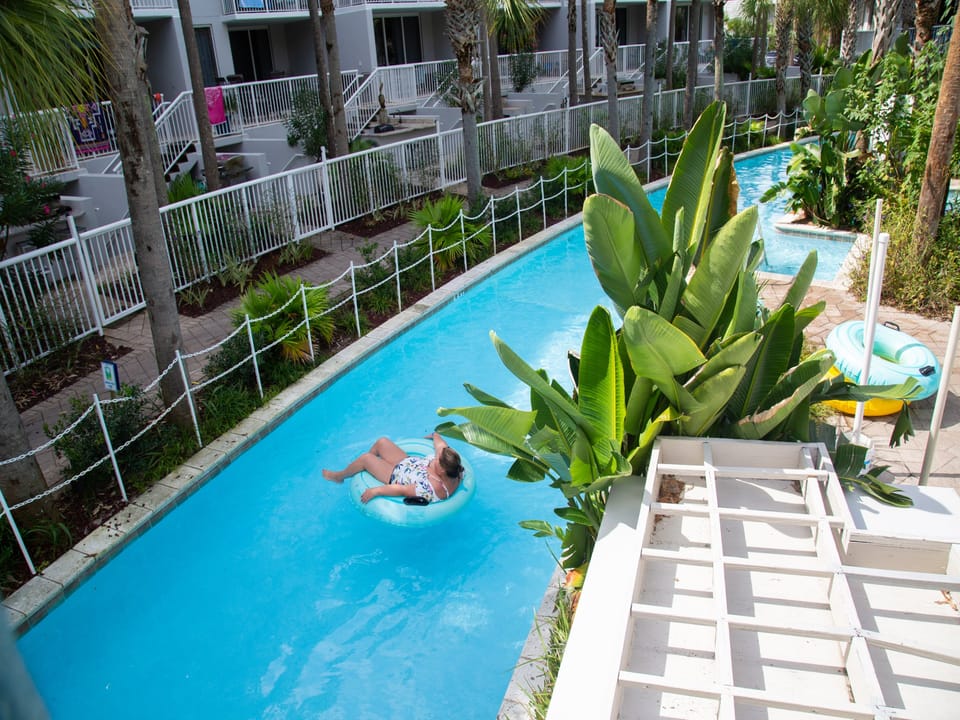 Float through your own tropical lazy river, surrounded by lush palms and peaceful waters that wind past your vacation home.