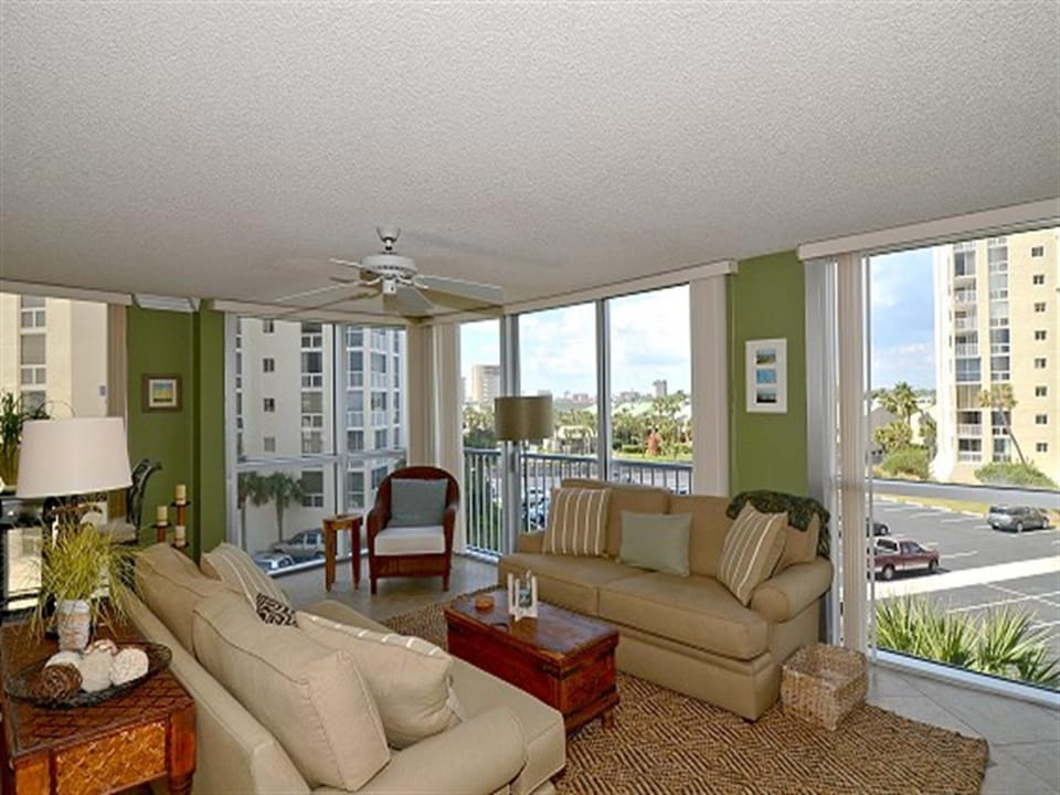Unwind in your spacious living room with panoramic city views through floor-to-ceiling windows.