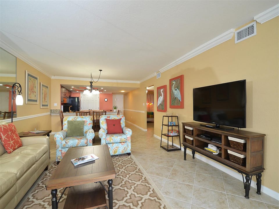 Unwind in your spacious living area with comfortable seating and large TV for cozy evenings after exploring.