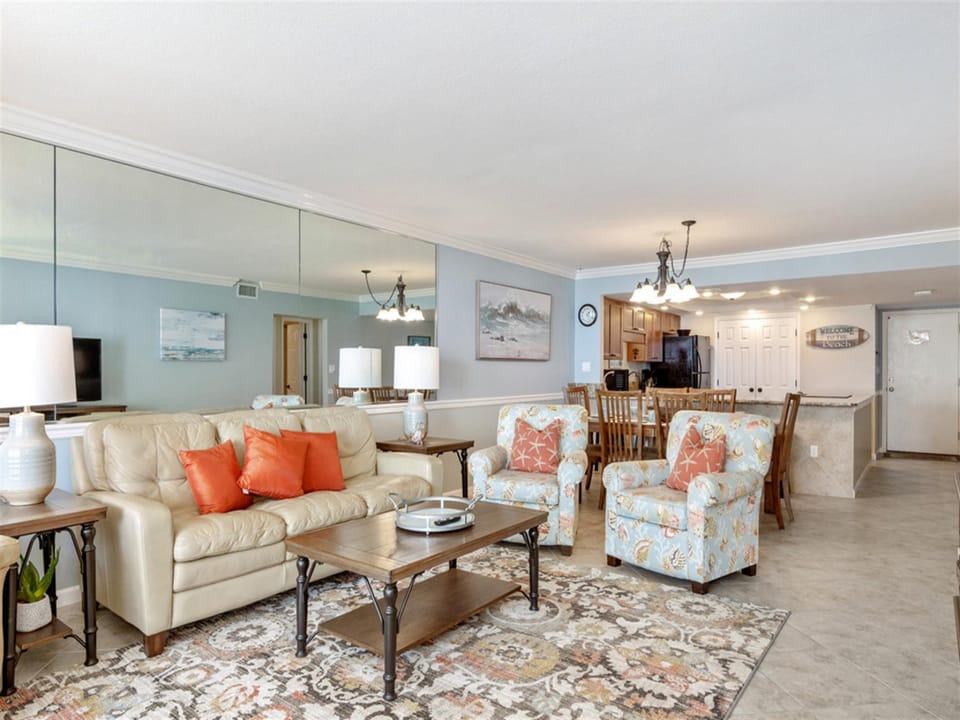 Relax in your spacious open-concept living area featuring plush seating and a fully equipped kitchen for memorable vacation moments.