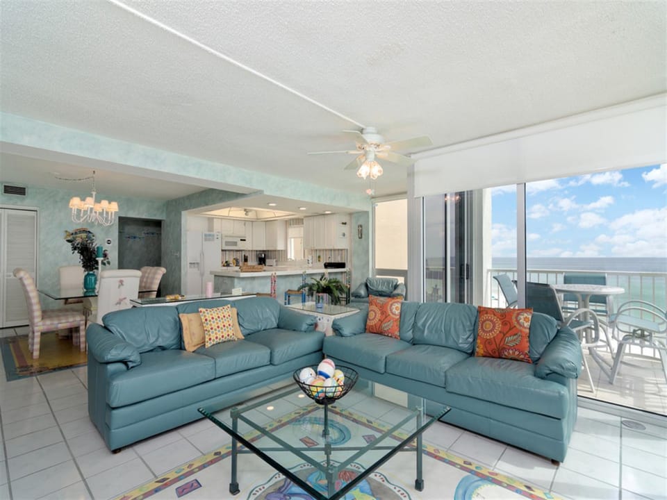 Settle into your spacious oceanfront living room, where coastal blues meet comfort and stunning sea views await beyond your private balcony.
