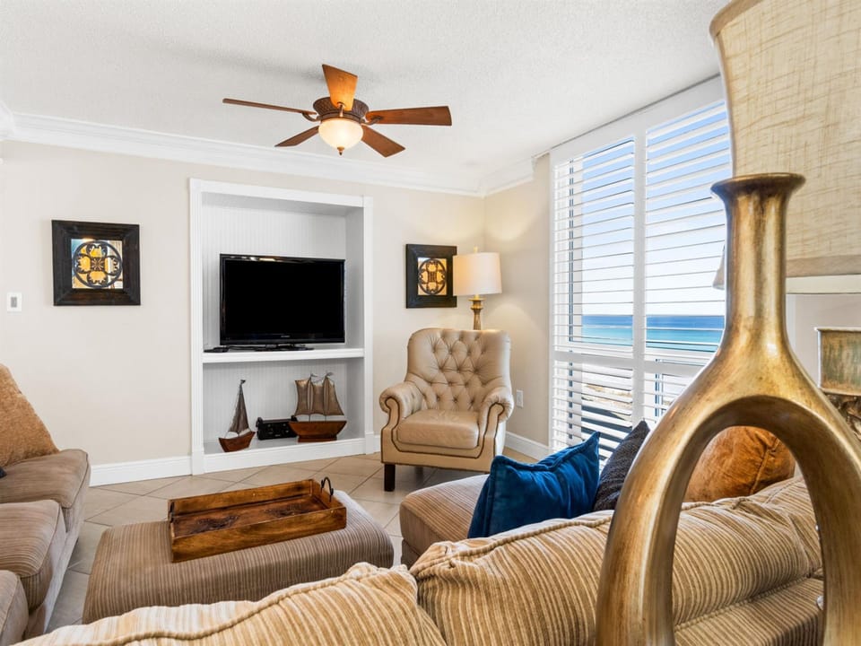 Relax in comfort with ocean views streaming through your window, cozy seating, and gentle sea breezes from the ceiling fan.