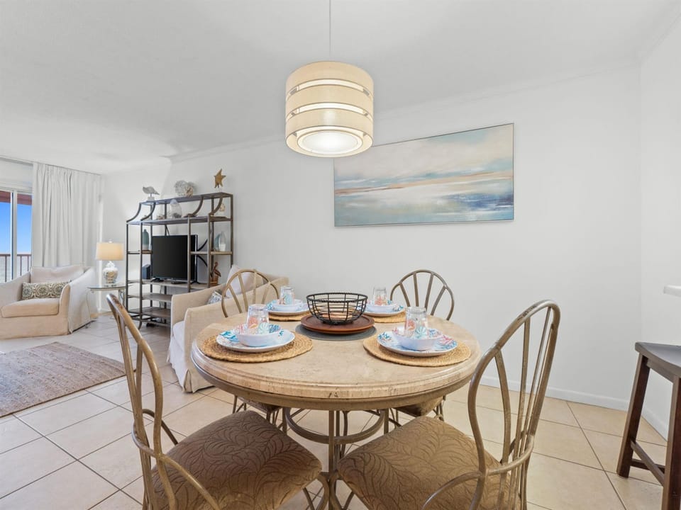 Gather around your beautifully set dining table, where coastal charm meets comfort in this bright, open living space designed for memorable meals.