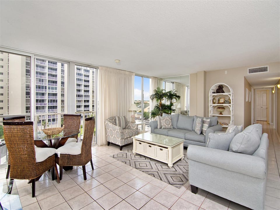 Your bright living space offers stunning city views through floor-to-ceiling windows, perfect for relaxing after exploring nearby attractions.