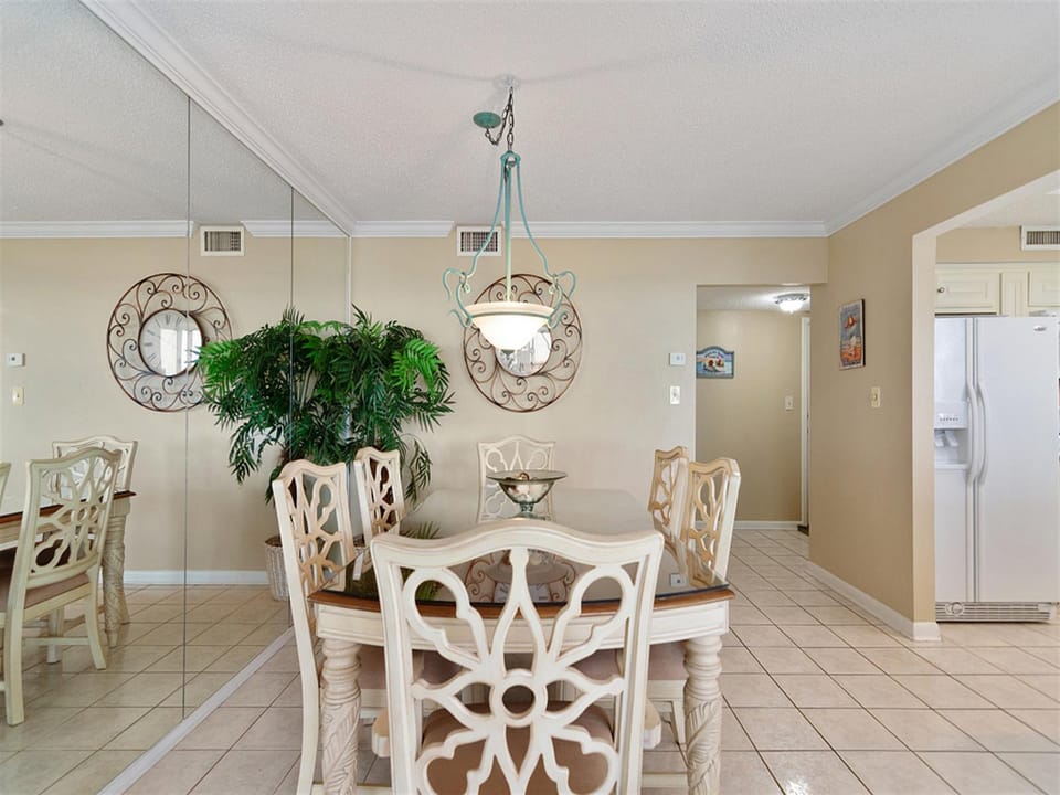Gather around your elegant dining table for memorable meals, where decorative mirrors and warm lighting create the perfect atmosphere for every occasion.