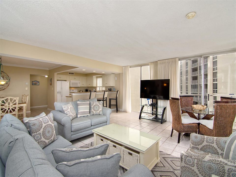 Sink into soft gray sofas and watch your favorite shows while city views stretch beyond the windows.