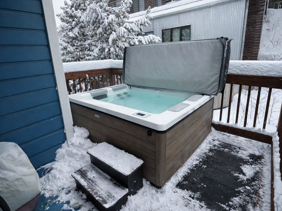 Soak in your private hot tub on the deck, surrounded by a winter wonderland—warm jets and snowy mountain views make for unforgettable alpine relaxation.