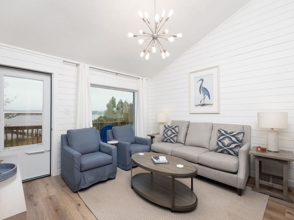 Open living area with ship lapped walls and coastal décor. Comfortably furnished to make you feel right at home.