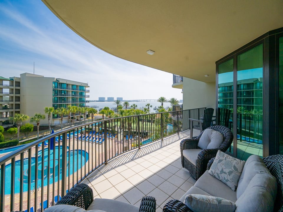 Relax on the balcony, taking in the refreshing coastal breeze and stunning views of the shimmering pool below